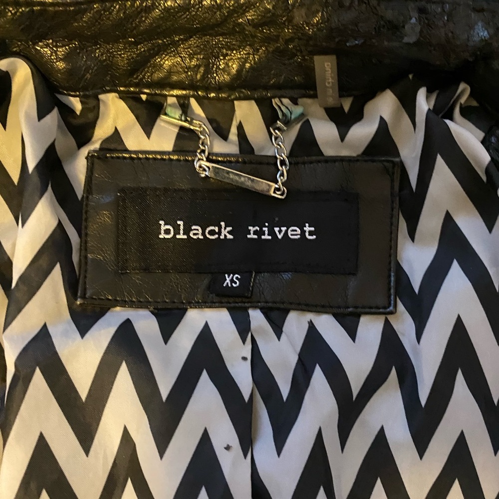 Black Rivet Leather Jacket with zebra print lining.